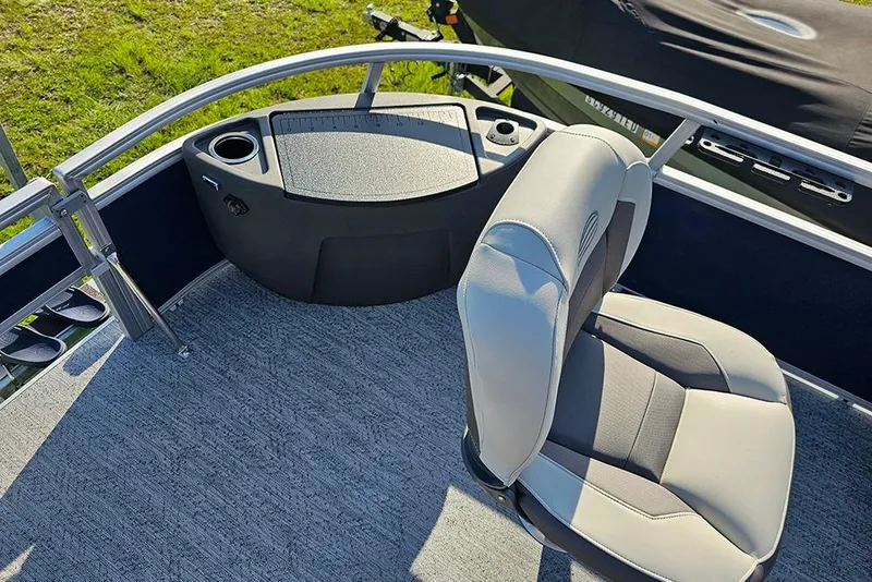 Slide: The Image of 2026 Sun Tracker Bass Buggy 18 DLX boat interior with seating and control panel. - 20