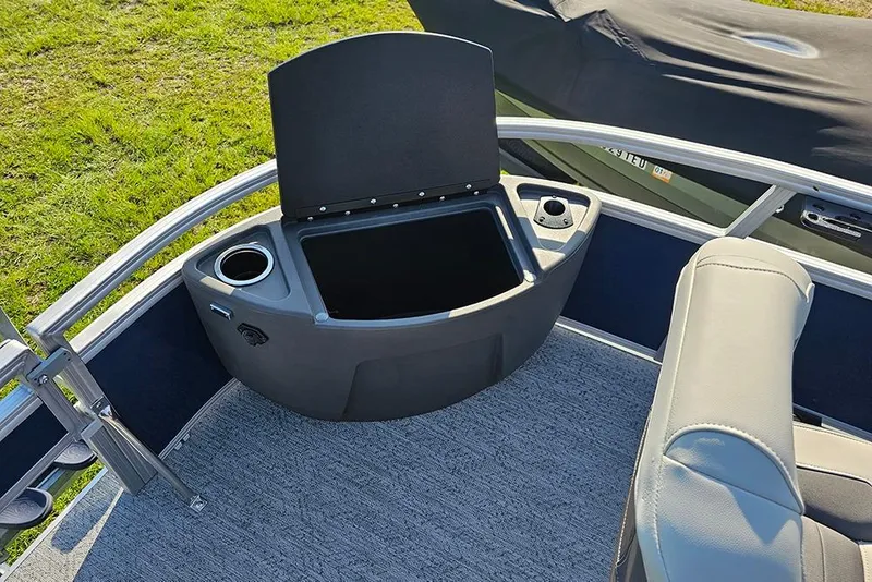 Slide: The Image of 2026 Sun Tracker Bass Buggy 18 DLX boat interior with seating and storage compartment. - 21