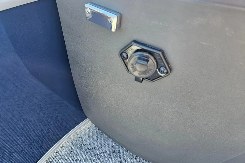 Slide: The Image of 2026 Sun Tracker Bass Buggy 18 DLX dashboard with a power outlet. - 22