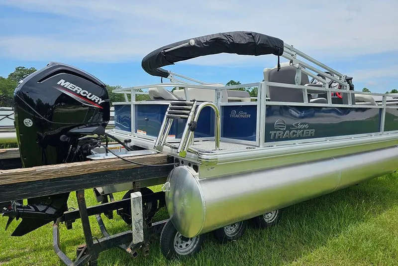 Slide: The Image of 2026 Sun Tracker Bass Buggy 18 DLX pontoon boat with Mercury engine on trailer. - 3