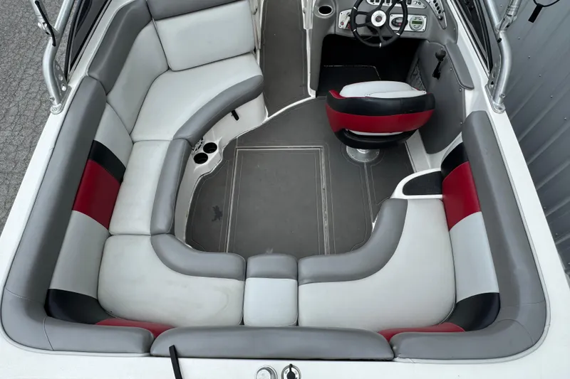 Slide: The Image of 2004 Tigé 22V Riders Edition boat interior with gray and red seating. - 3