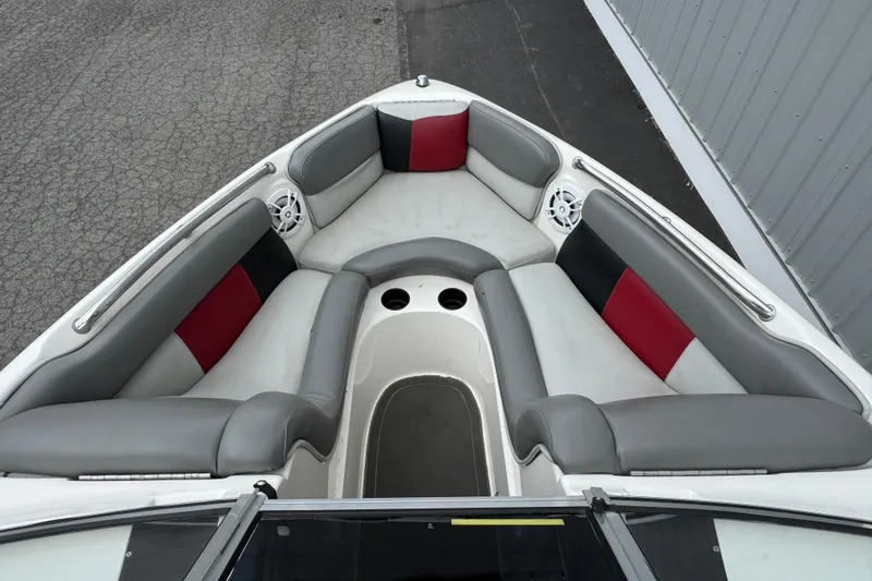 Slide: The Image of 2004 Tigé 22V Riders Edition boat interior with gray and red seating. - 5
