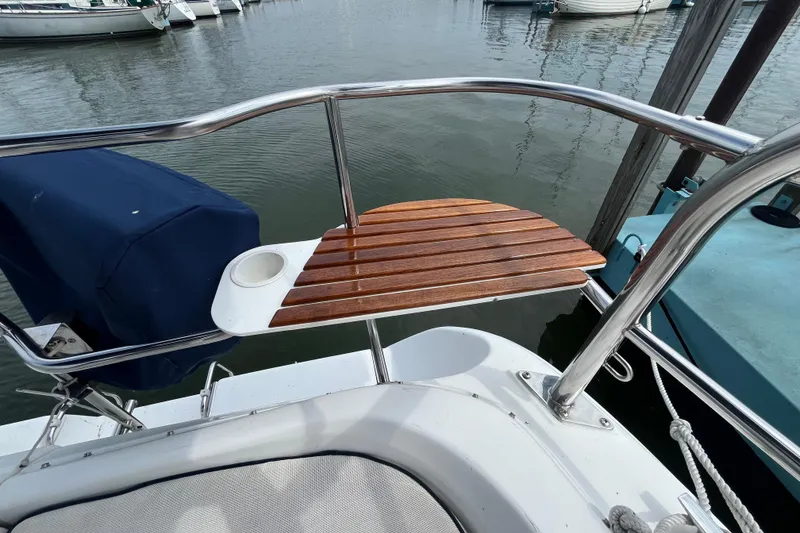 Slide: The Image of Hunter 36-2 sailboat stern with wooden seat and cup holder, docked in marina, 2006 model. - 10