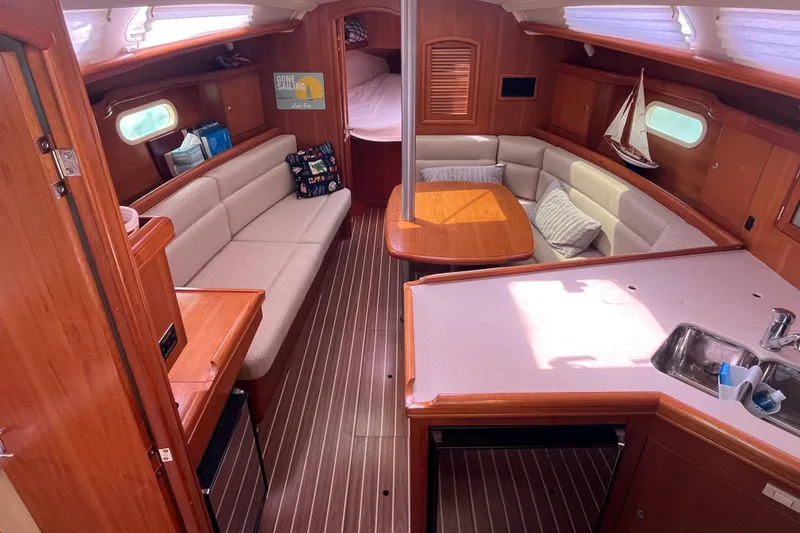 Slide: The Image of Interior of 2006 Hunter 36-2 sailboat with cozy seating and wooden finishes. - 16