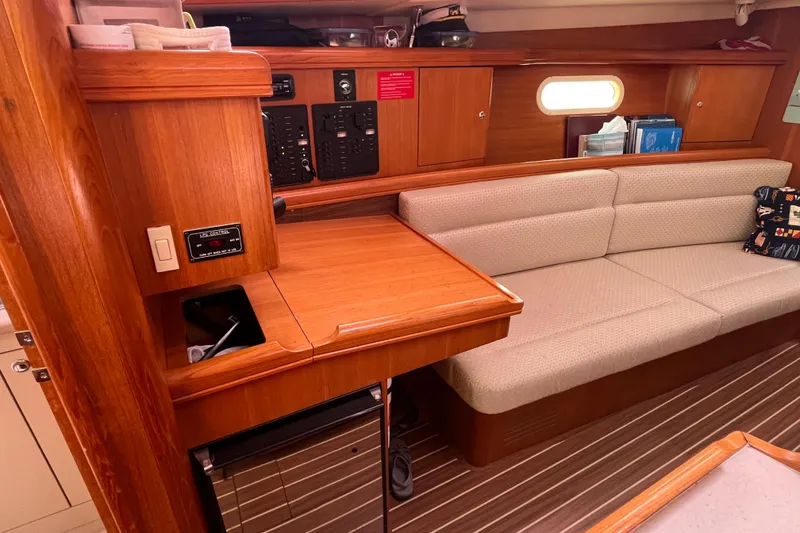 Slide: The Image of Interior of 2006 Hunter 36-2 sailboat with wooden cabinetry and beige seating. - 19