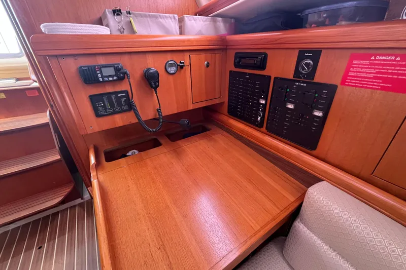 Slide: The Image of Wooden navigation station in a 2006 Hunter 36-2 sailboat with communication equipment. - 20