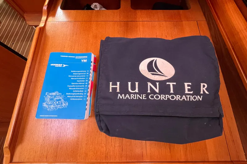 Slide: The Image of Hunter 36-2 2006 manual and cover on wooden surface. - 23