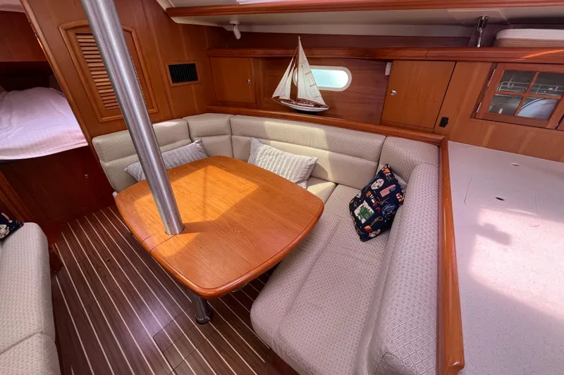 Slide: The Image of Interior of 2006 Hunter 36-2 sailboat with cozy seating and wooden table. - 24
