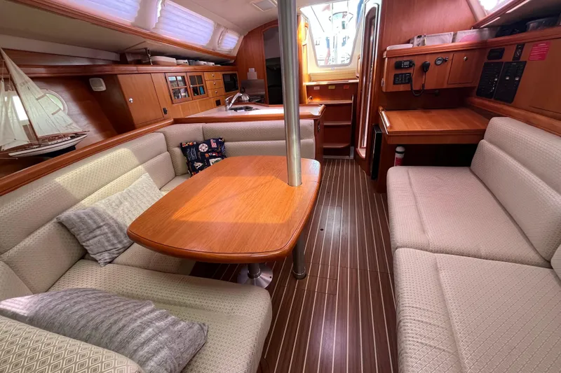 Slide: The Image of Interior of a 2006 Hunter 36-2 sailboat with cozy seating and wooden finishes. - 26
