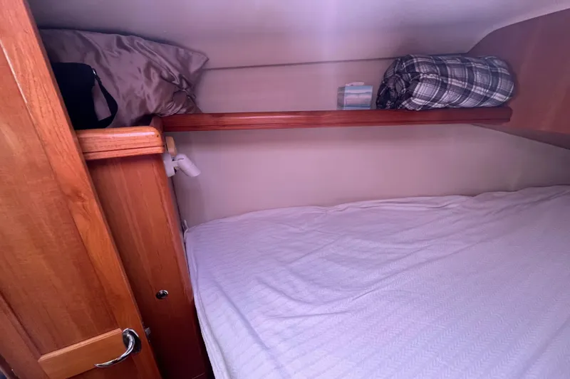 Slide: The Image of Cozy cabin interior of 2006 Hunter 36-2 sailboat with wooden accents and bedding. - 34