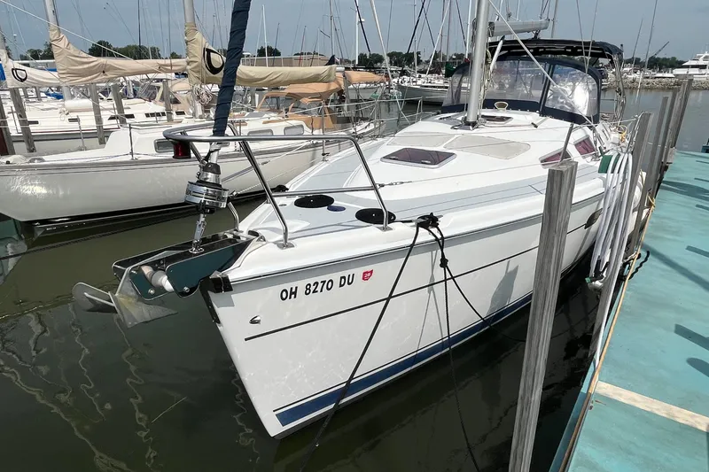 Slide: The Image of 2006 Hunter 36-2 sailboat docked at marina, white hull, calm water. - 38
