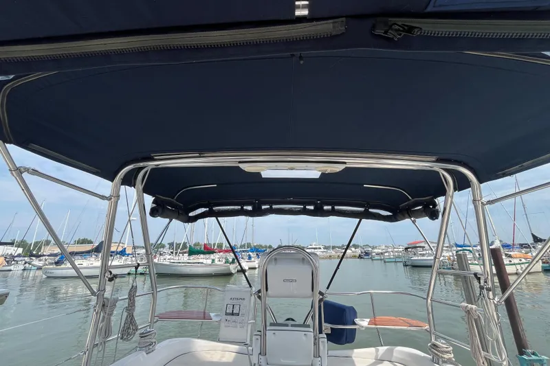 Slide: The Image of 2006 Hunter 36-2 sailboat cockpit with marina view, featuring a navy bimini top. - 8