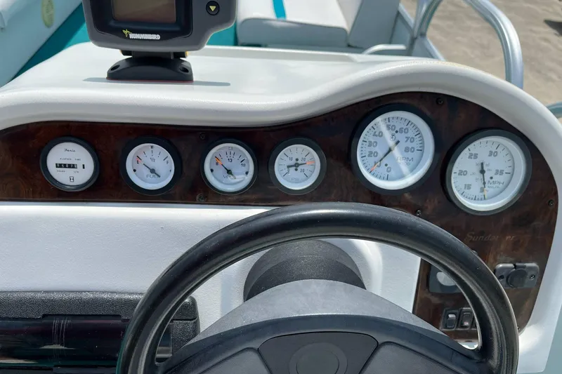 Slide: The Image of Dashboard of a 1998 Sundancer Pontoons 240 with gauges and steering wheel. - 5