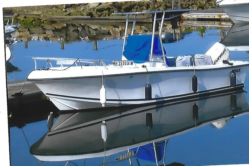 The Image of 2001 Mako 221 Center Console boat docked on calm water. - 0