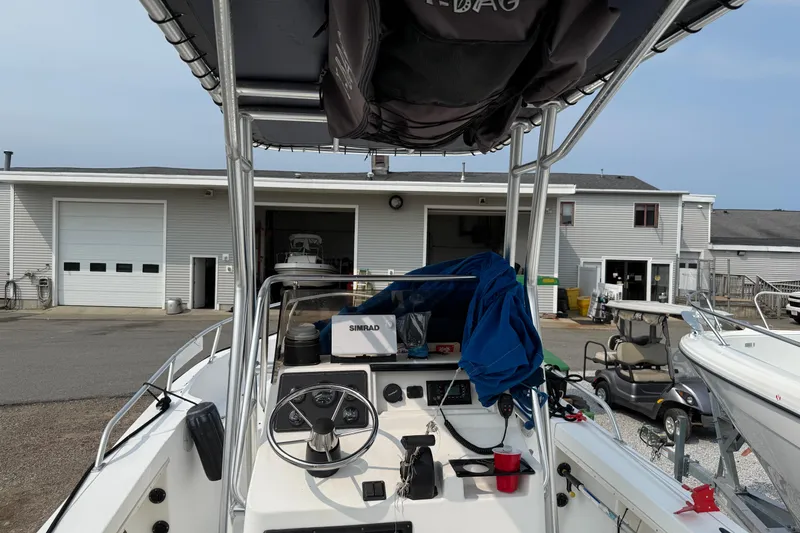 Slide: The Image of 2001 Mako 221 Center Console boat at a marina, featuring steering wheel and navigation equipment. - 6