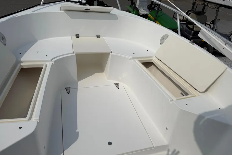 Slide: The Image of 2001 Mako 221 Center Console boat interior with storage compartments open. - 8
