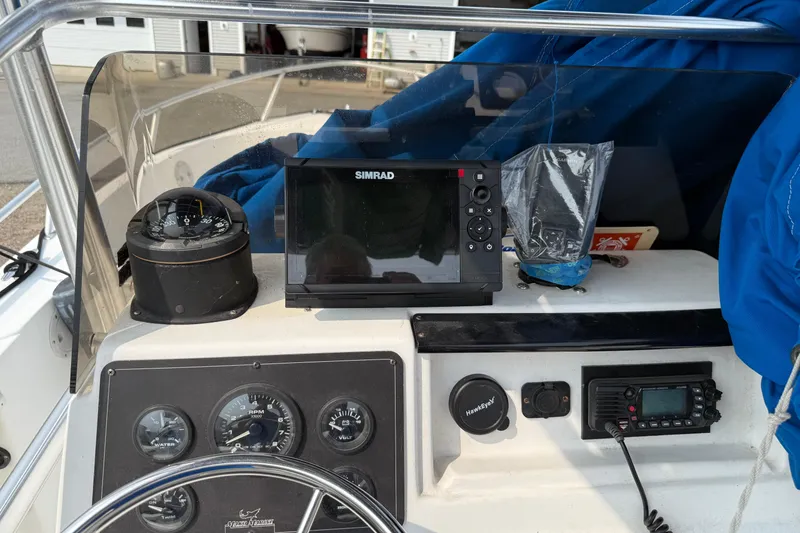 Slide: The Image of 2001 Mako 221 Center Console dashboard with navigation equipment and gauges. - 9