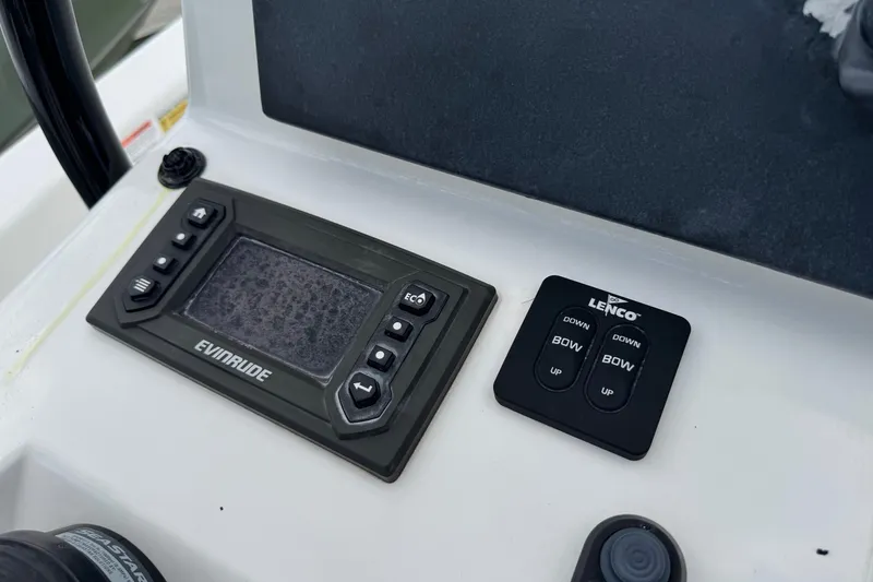 Slide: The Image of Control panel of a 2015 BlackJack 224 Bay boat with Evinrude and Lenco systems. - 13