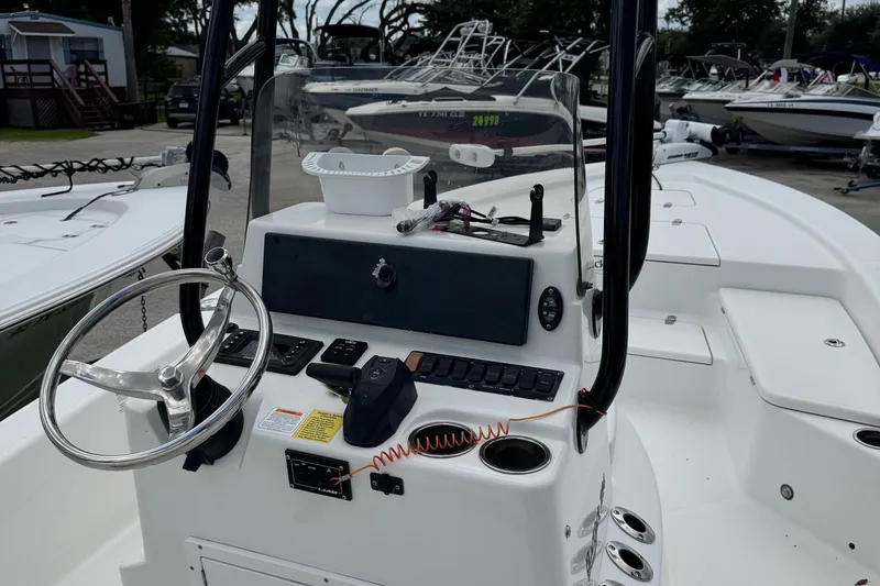 Slide: The Image of 2015 BlackJack 224 Bay boat console with steering wheel and controls. - 16