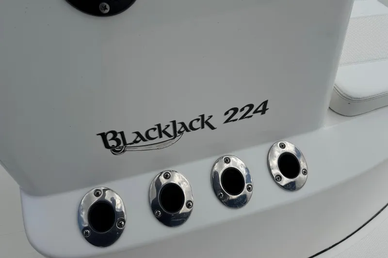 Slide: The Image of 2015 BlackJack 224 Bay boat with rod holders and logo detail. - 17
