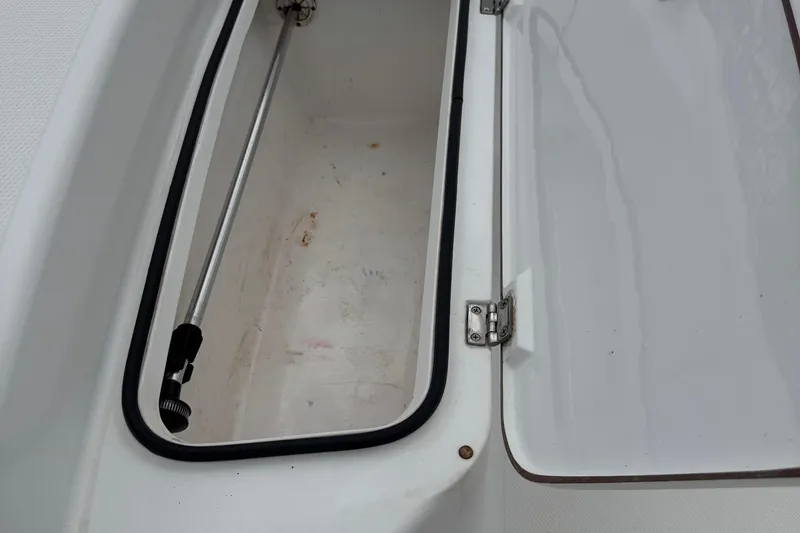 Slide: The Image of Open storage compartment on a 2015 BlackJack 224 Bay boat. - 22