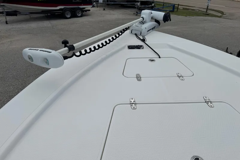 Slide: The Image of 2015 BlackJack 224 Bay boat deck with trolling motor and storage hatches. - 25