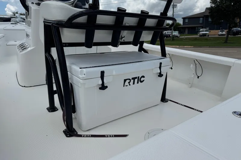Slide: The Image of 2015 BlackJack 224 Bay boat with RTIC cooler under seat, white interior. - 29