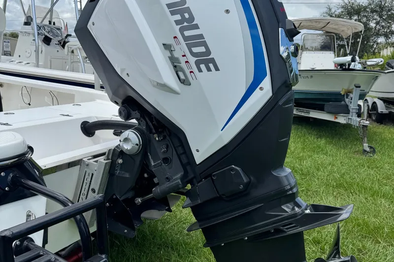 Slide: The Image of 2015 BlackJack 224 Bay boat with Evinrude E-TEC outboard motor in grassy area. - 3