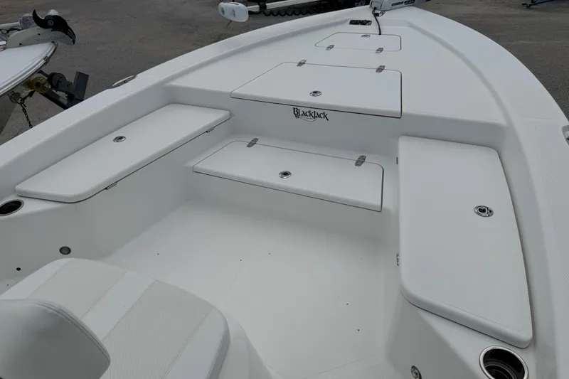 Slide: The Image of 2015 BlackJack 224 Bay boat interior with white seating and storage compartments. - 31