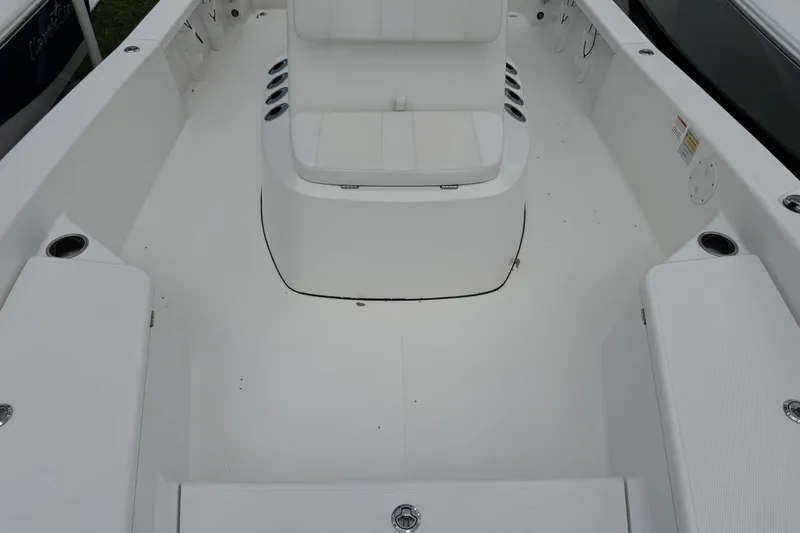 Slide: The Image of 2015 BlackJack 224 Bay boat interior with white seating and spacious deck layout. - 32