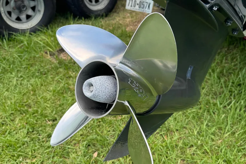Slide: The Image of Close-up of a 2015 BlackJack 224 Bay boat propeller on grass. - 4