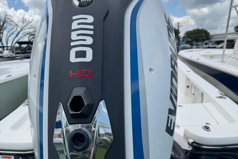 Slide: The Image of 2015 BlackJack 224 Bay boat with Evinrude 250 HP engine, docked under cloudy sky. - 5