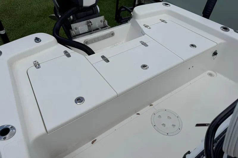 Slide: The Image of 2015 BlackJack 224 Bay boat interior with storage compartments and motor. - 9