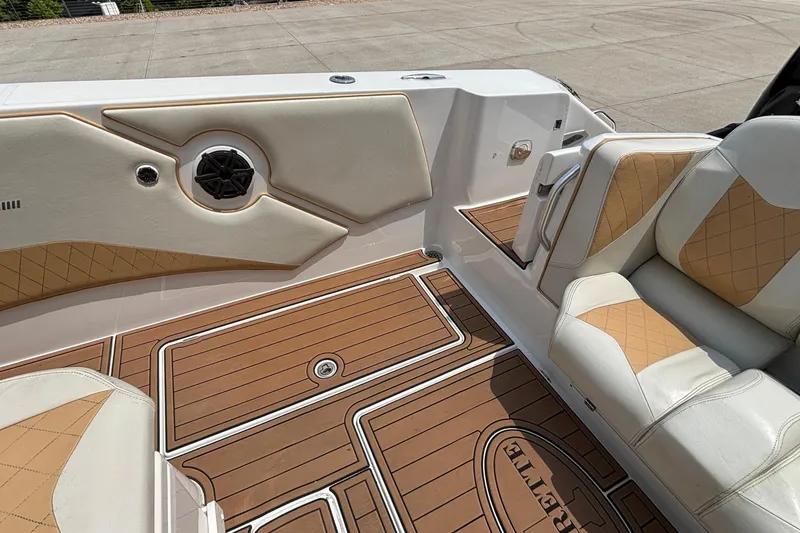 Slide: The Image of Interior of 2014 Cigarette 39 GTS boat with tan and white seating and wood-patterned flooring. - 10