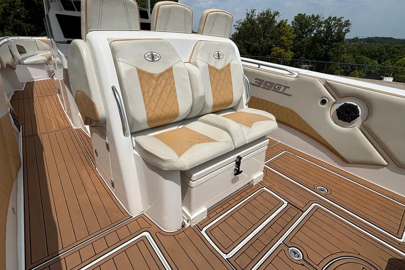 Slide: The Image of 2014 Cigarette 39 GTS boat interior with tan and white seating, teak flooring. - 11
