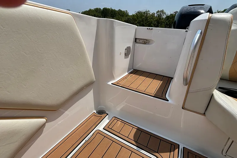 Slide: The Image of Interior view of a 2014 Cigarette 39 GTS boat, featuring cushioned seating and teak flooring. - 14