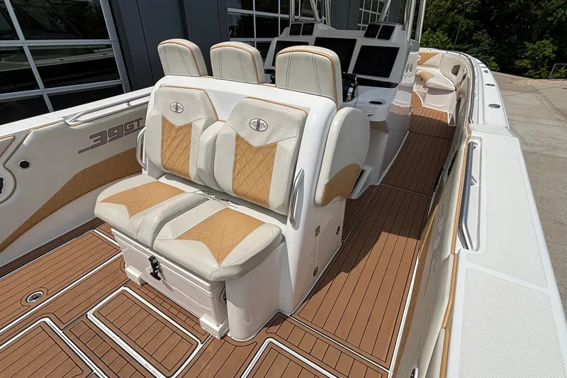 Slide: The Image of 2014 Cigarette 39 GTS boat interior with tan and white seating, wood flooring. - 16