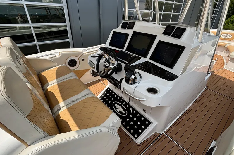 Slide: The Image of 2014 Cigarette 39 GTS boat cockpit with modern controls and tan seating. - 18