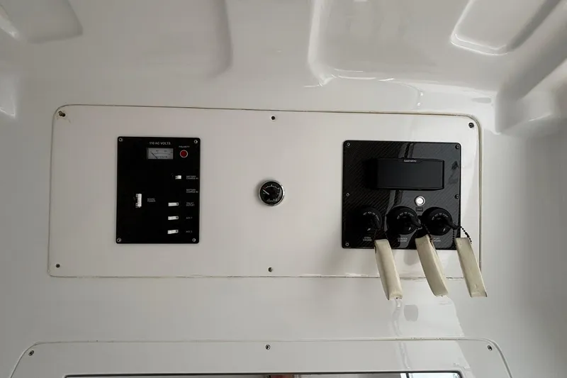 Slide: The Image of Control panel of a 2014 Cigarette 39 GTS boat with switches and gauges. - 49