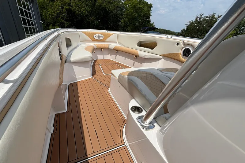 Slide: The Image of 2014 Cigarette 39 GTS boat interior with tan and white seating, wood-style flooring. - 28
