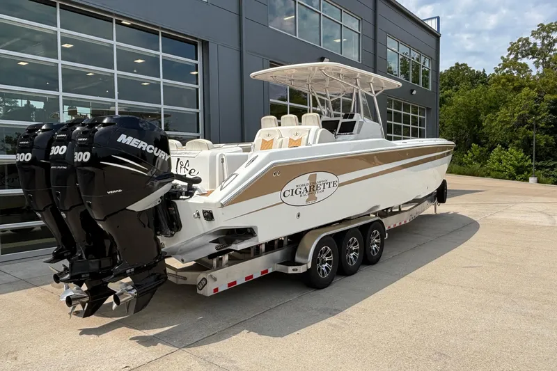Slide: The Image of 2014 Cigarette 39 GTS boat with triple Mercury engines on a trailer. - 2