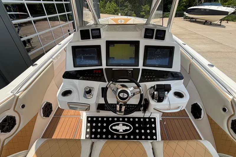 Slide: The Image of 2014 Cigarette 39 GTS boat cockpit with advanced navigation displays and luxurious seating. - 20