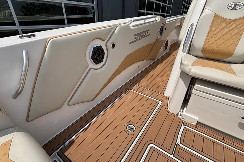 Slide: The Image of 2014 Cigarette 39 GTS boat interior with tan and white seating, wood-style flooring. - 22
