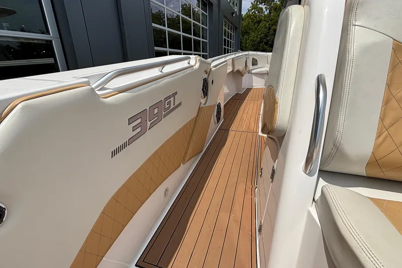 Slide: The Image of 2014 Cigarette 39 GTS boat interior with tan upholstery and wood flooring. - 23