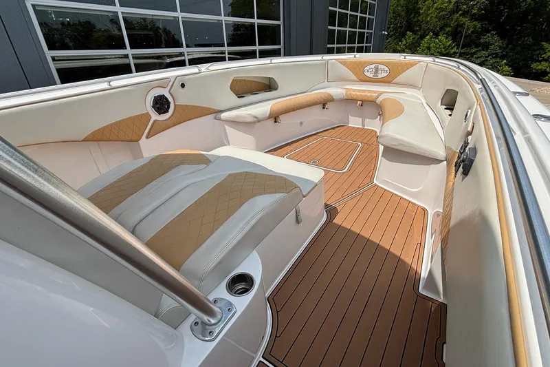 Slide: The Image of 2014 Cigarette 39 GTS boat interior with tan and white seating, wood-style flooring. - 33