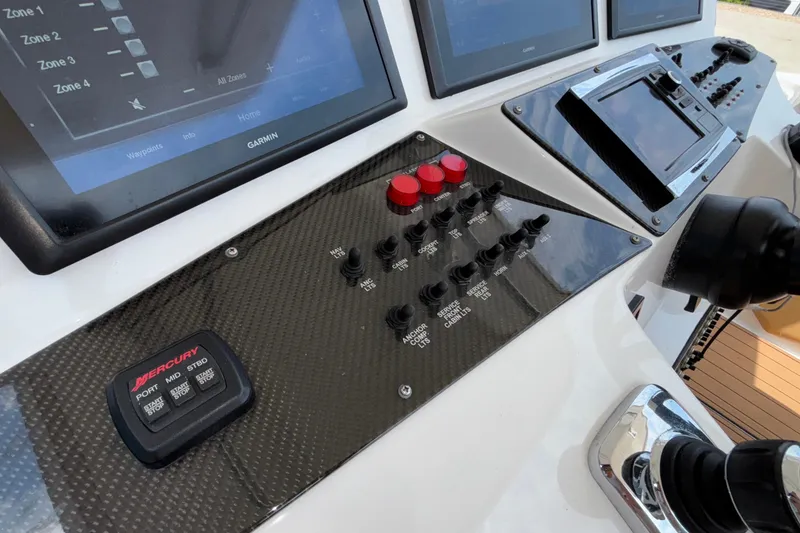 Slide: The Image of Control panel of 2014 Cigarette 39 GTS boat with Garmin displays and Mercury controls. - 25