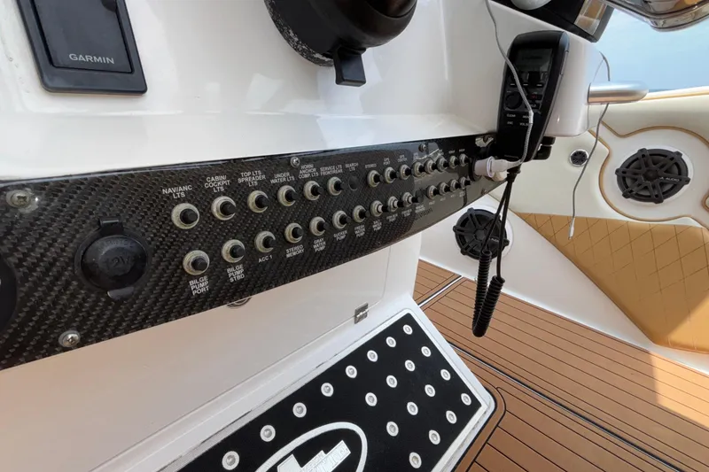 Slide: The Image of Control panel of a 2014 Cigarette 39 GTS boat with switches and radio. - 26