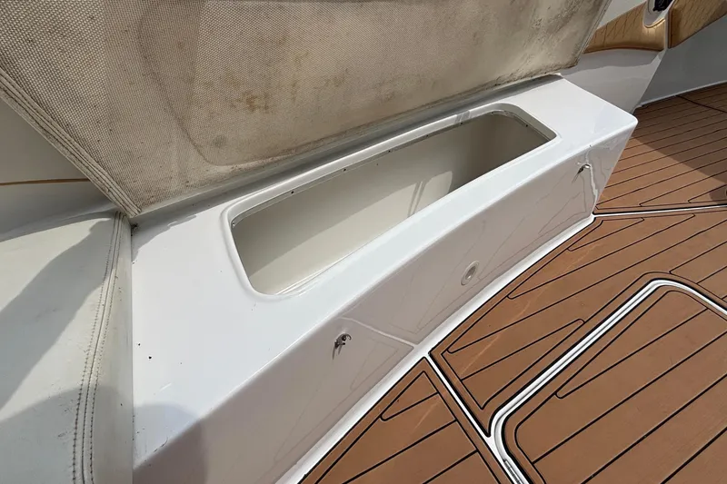 Slide: The Image of Open storage compartment on 2014 Cigarette 39 GTS boat with teak flooring. - 43