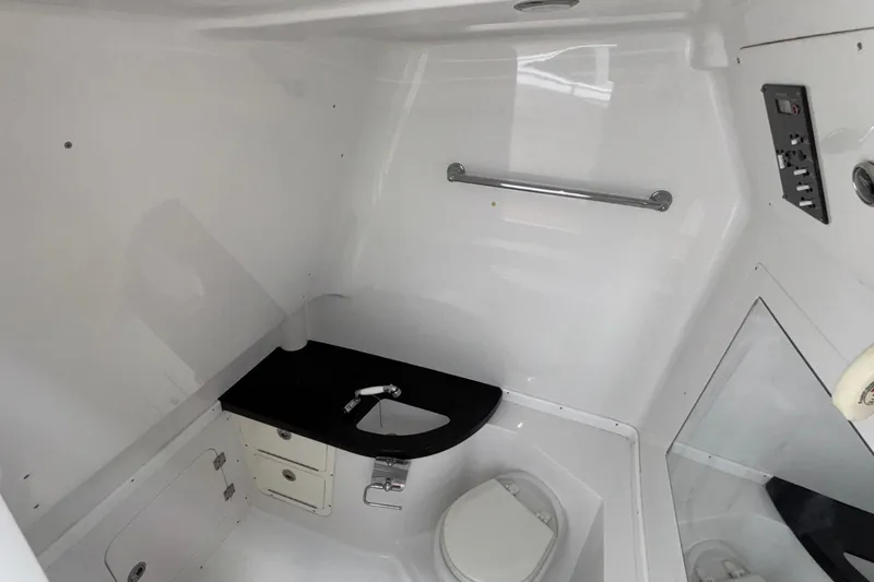 Slide: The Image of 2014 Cigarette 39 GTS boat interior bathroom with toilet and sink. - 39
