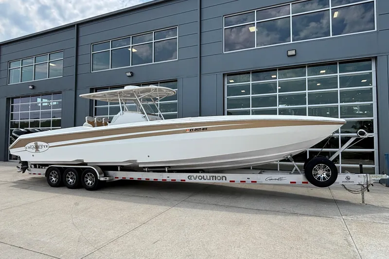 Slide: The Image of 2014 Cigarette 39 GTS boat on trailer, parked outside a modern building. - 3